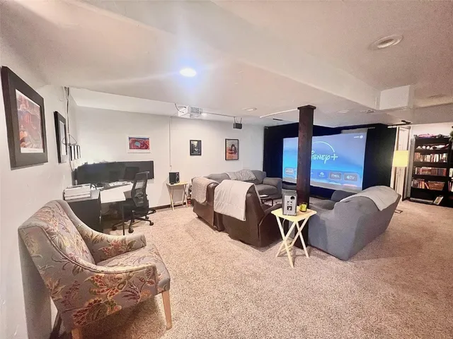 a living room with furniture a air conditioner vent and a window