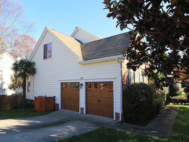 9908 Wyngate Ridge Drive Raleigh, NC 27617 - Photo 19 of 20 Custom Door and Gate garage doors with new electric openers including track, springs, etc. Nice side-load garage with a gladiator storage system that every man will love. Come see! Garage