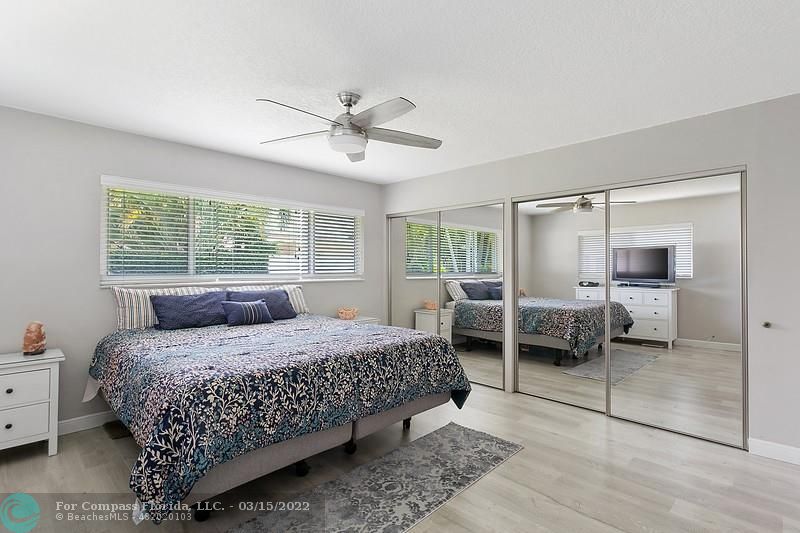 1948 Sailfish Place Lauderdale-by-the-Sea, FL 33062 - Photo 13 of 33 a bedroom with a bed and a mirror
