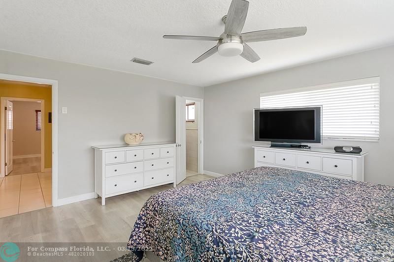 1948 Sailfish Place Lauderdale-by-the-Sea, FL 33062 - Photo 14 of 33 a bedroom with a bed and a flat screen tv