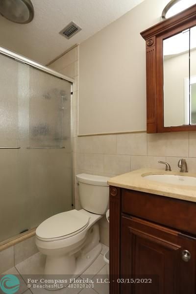 1948 Sailfish Place Lauderdale-by-the-Sea, FL 33062 - Photo 15 of 33 a bathroom with a sink a toilet and shower