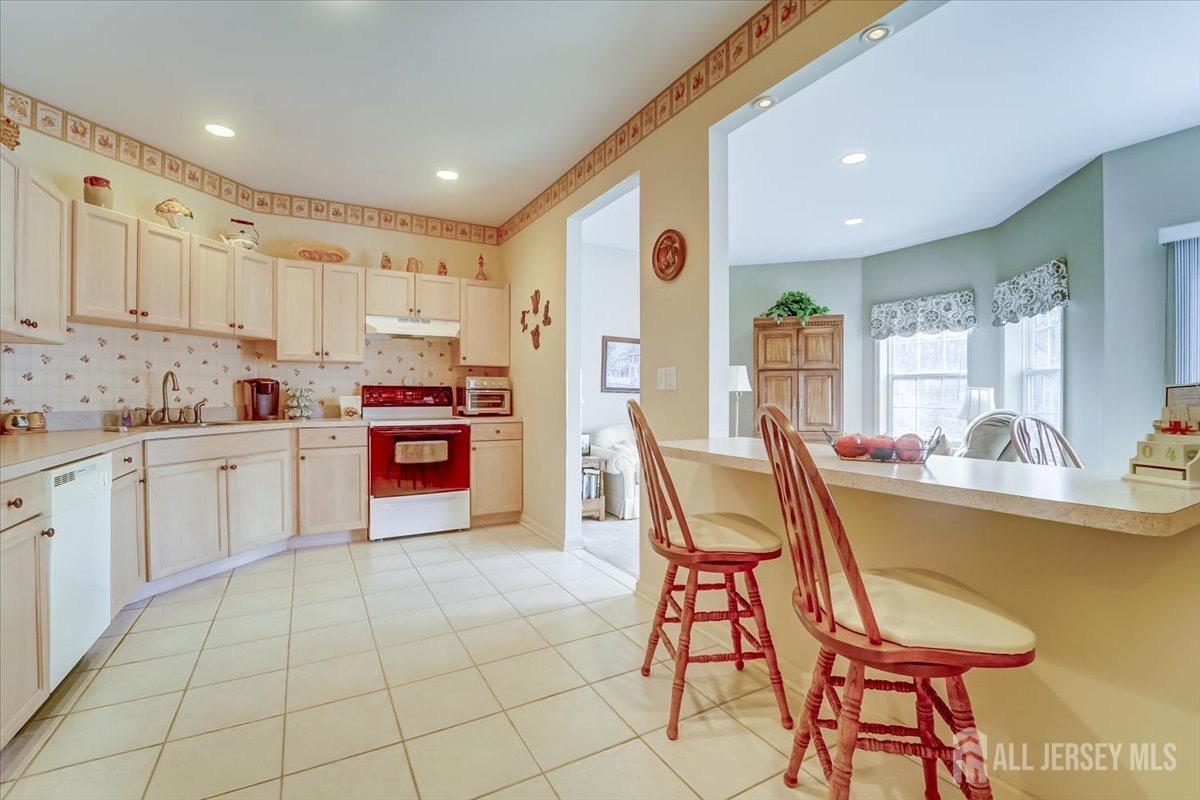 375 Rifle Camp Road, Unit 409 Woodland Park, NJ 07424 - Photo 12 of 22 a kitchen with a sink cabinets and window