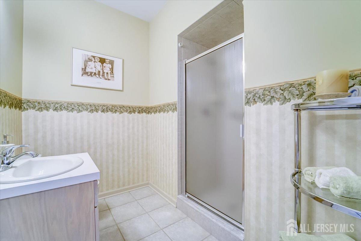 375 Rifle Camp Road, Unit 409 Woodland Park, NJ 07424 - Photo 13 of 22 a bathroom with a sink and a mirror