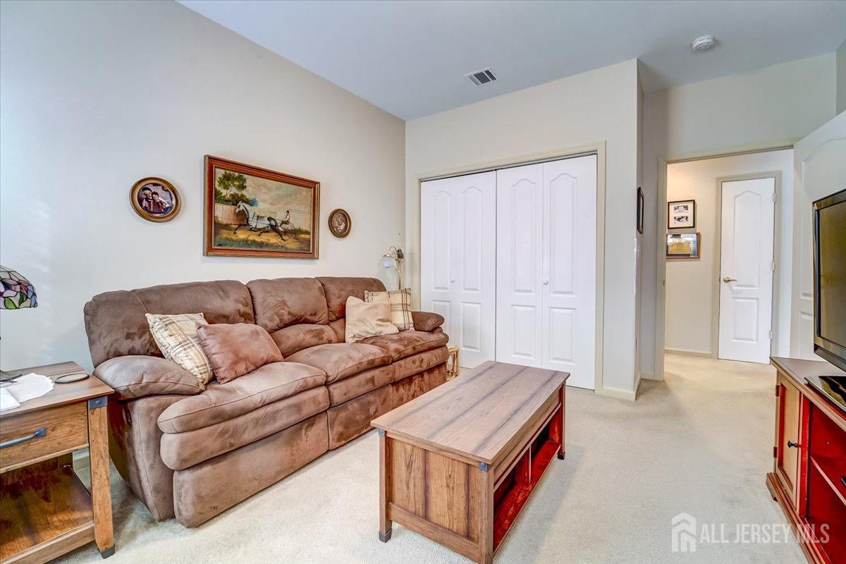375 Rifle Camp Road, Unit 409 Woodland Park, NJ 07424 - Photo 15 of 22 a living room with furniture and a gate