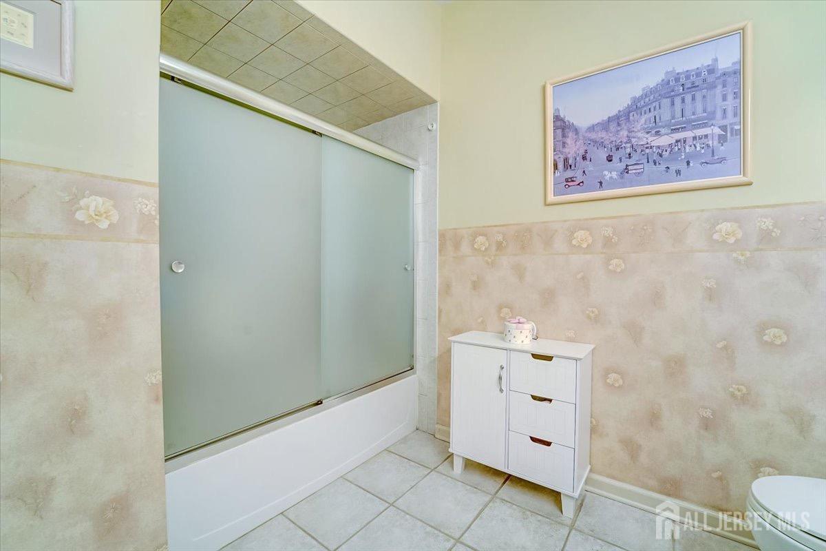 375 Rifle Camp Road, Unit 409 Woodland Park, NJ 07424 - Photo 16 of 22 a bathroom with a bathtub and a shower