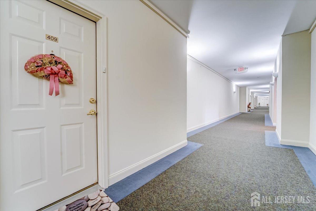 375 Rifle Camp Road, Unit 409 Woodland Park, NJ 07424 - Photo 17 of 22 a view of a hallway to a room