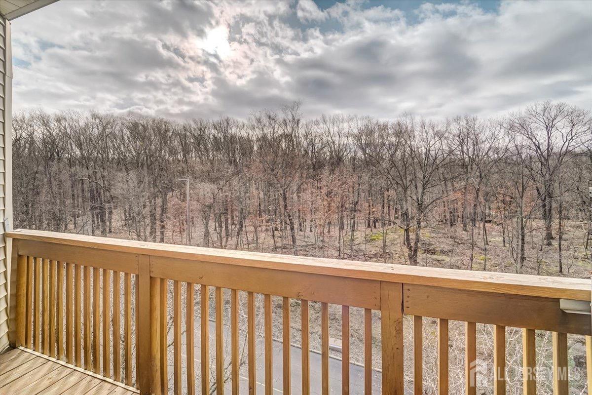375 Rifle Camp Road, Unit 409 Woodland Park, NJ 07424 - Photo 7 of 22 a view of a balcony next to a yard