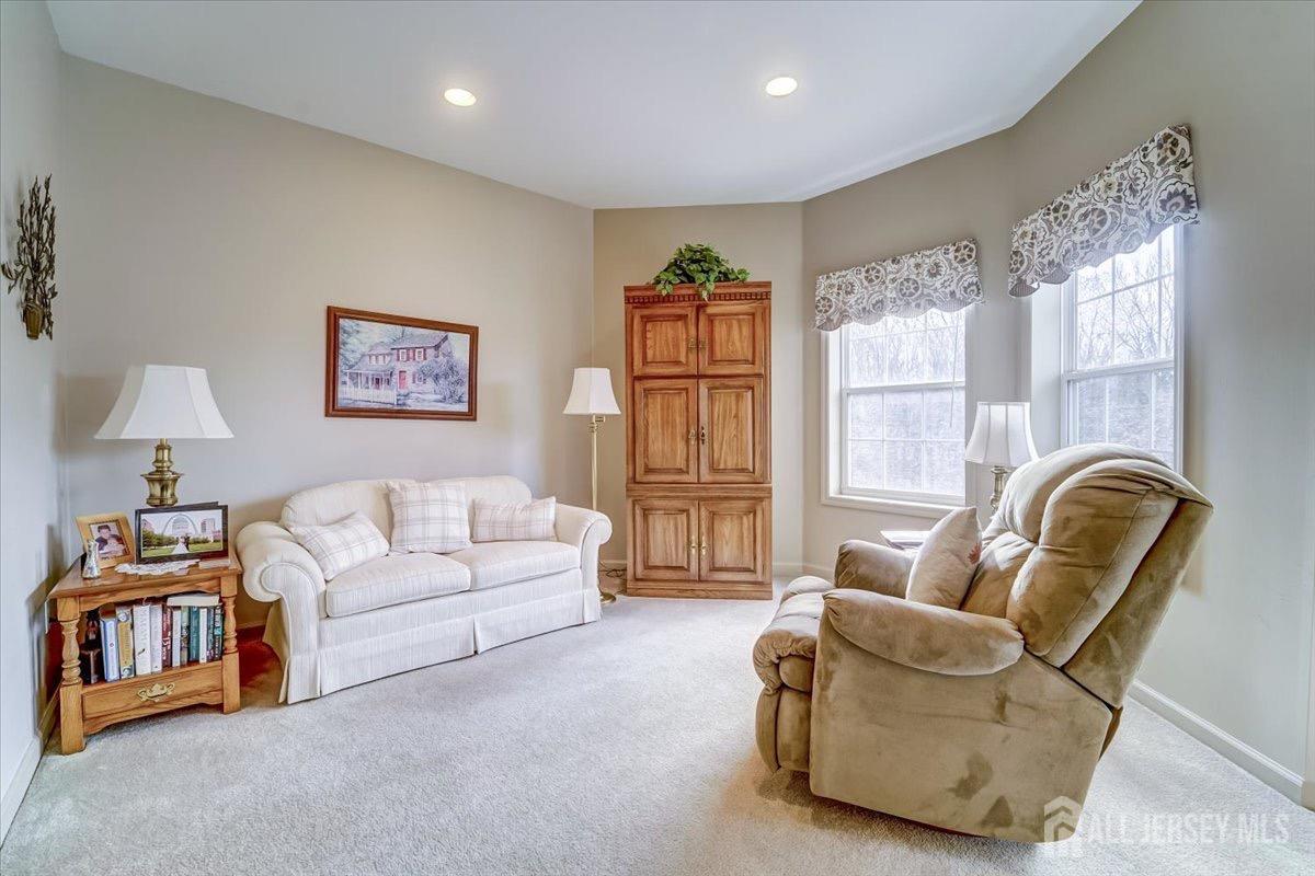 375 Rifle Camp Road, Unit 409 Woodland Park, NJ 07424 - Photo 8 of 22 a living room with furniture and a window