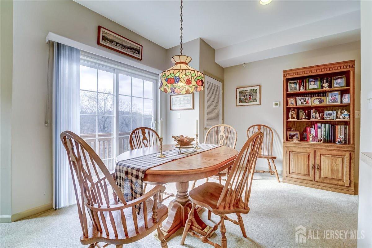 375 Rifle Camp Road, Unit 409 Woodland Park, NJ 07424 - Photo 9 of 22 a dining room with furniture a rug and wooden floor