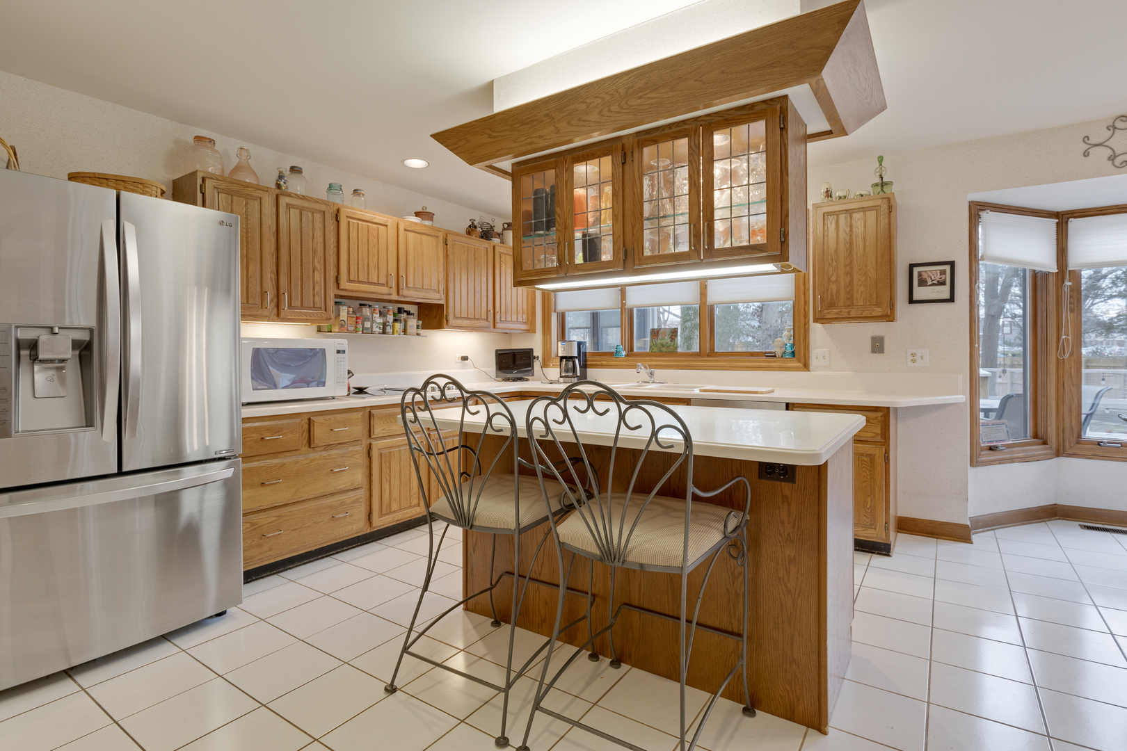 1133 Edgewater Drive Naperville, IL 60540 - Photo 11 of 37 a kitchen with granite countertop a refrigerator and a stove top oven