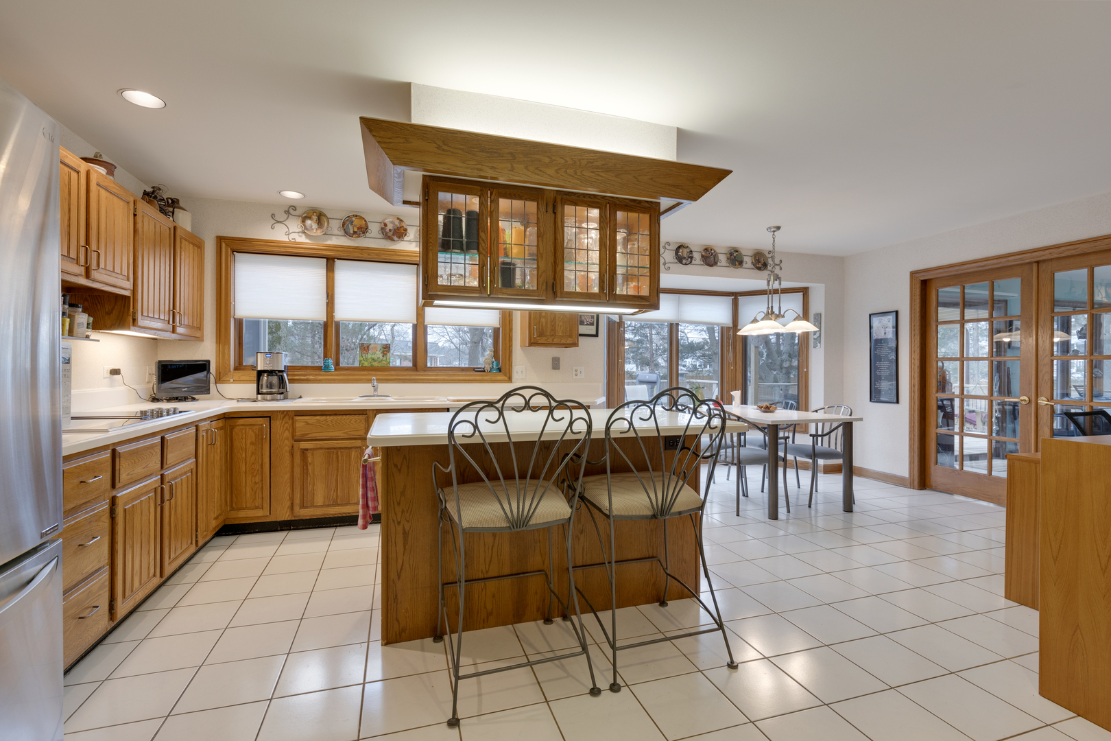 1133 Edgewater Drive Naperville, IL 60540 - Photo 12 of 37 a kitchen with stainless steel appliances granite countertop a stove a sink a dining table and chairs