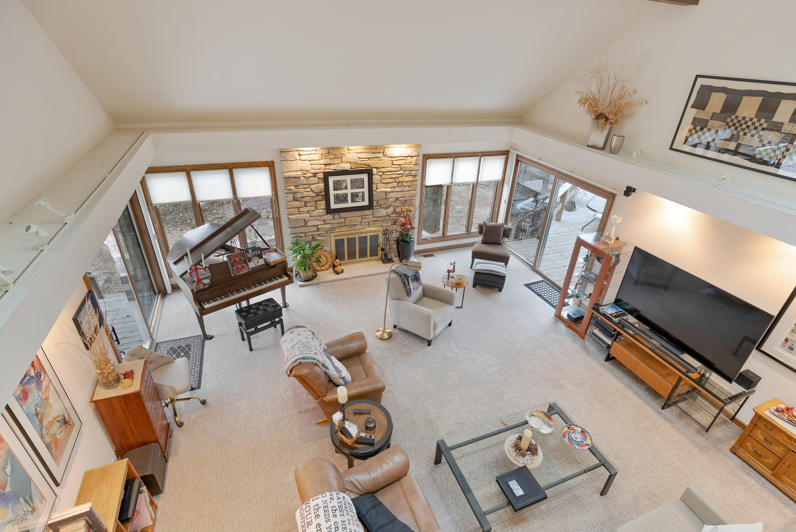 1133 Edgewater Drive Naperville, IL 60540 - Photo 20 of 37 a living room with furniture a flat screen tv and a floor to ceiling window
