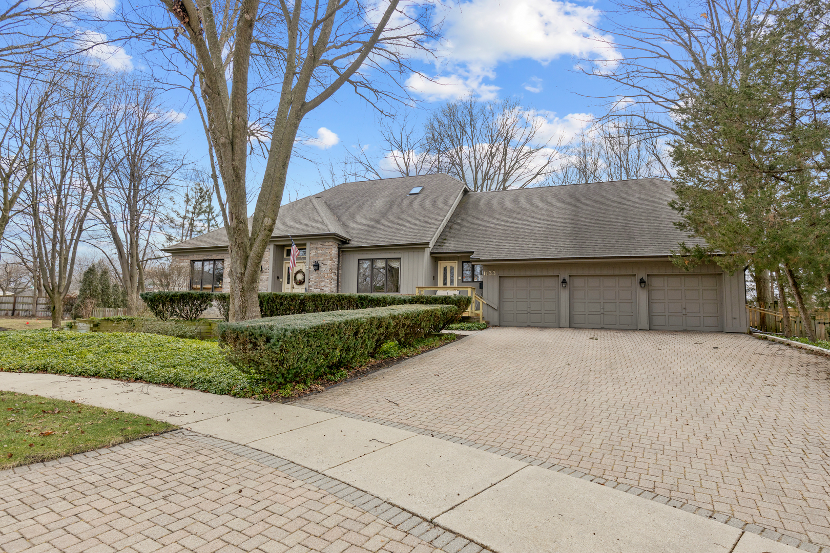 1133 Edgewater Drive Naperville, IL 60540 - Photo 2 of 37 a view of a house with a yard covered with plants and large trees