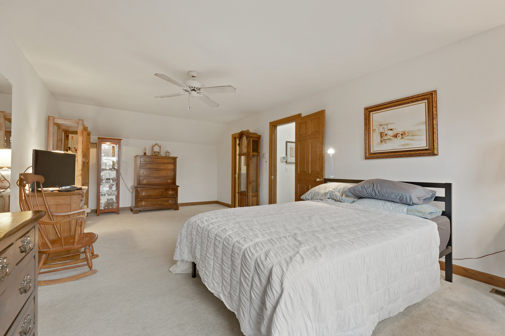 1133 Edgewater Drive Naperville, IL 60540 - Photo 22 of 37 a spacious bedroom with a bed and dresser