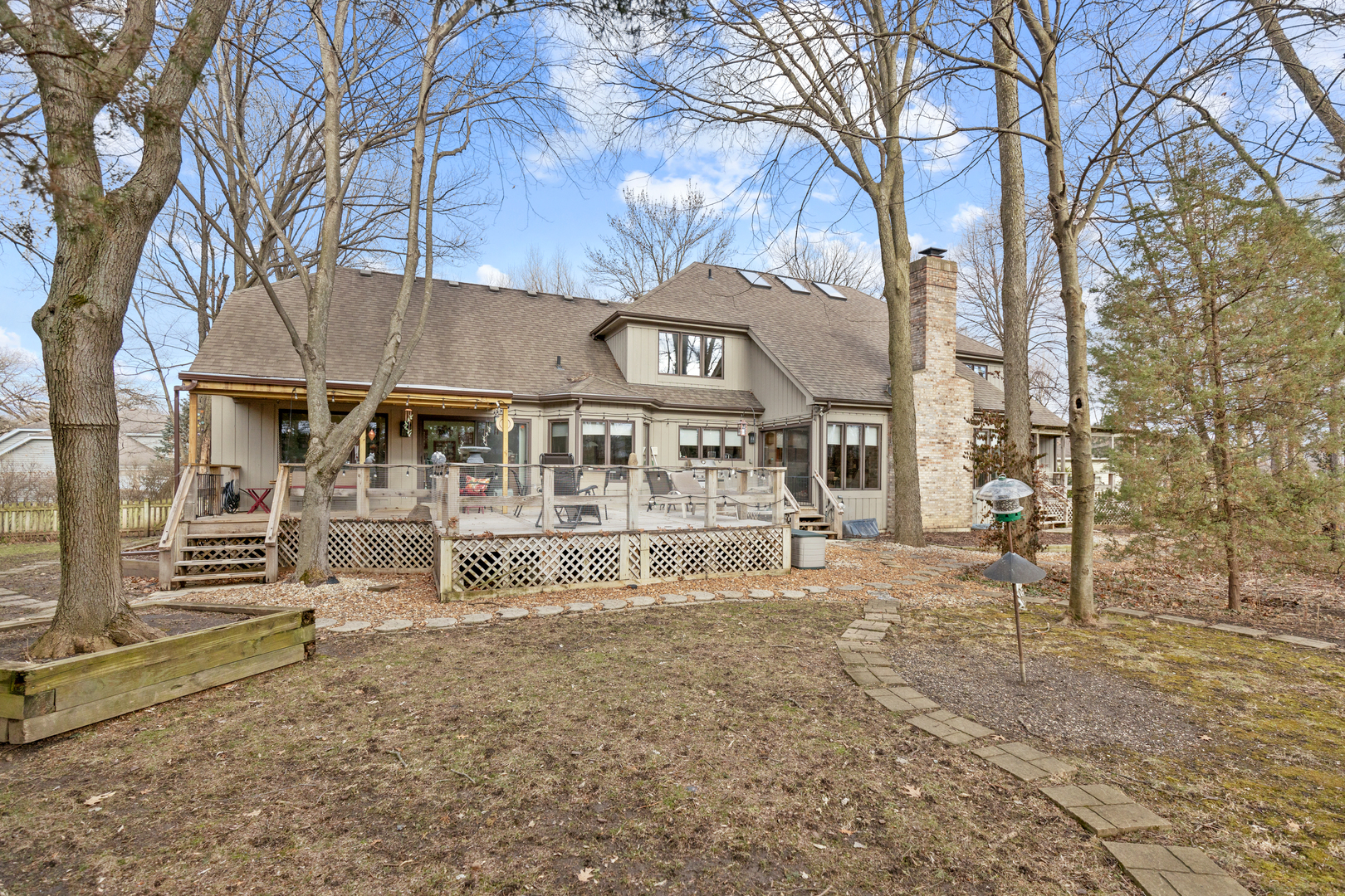 1133 Edgewater Drive Naperville, IL 60540 - Photo 33 of 37 a white house that has a tree in front of it