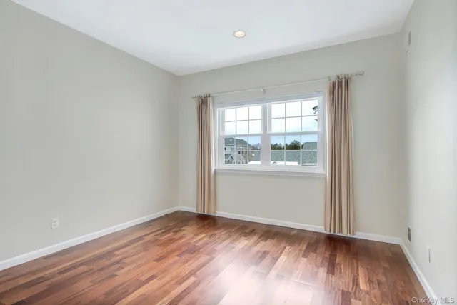 a large kitchen with cabinets wooden floor and stainless steel appliances