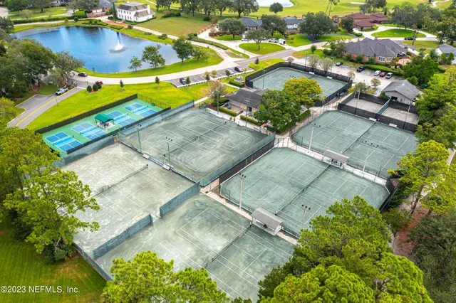 an aerial view of residential houses with outdoor space and swimming pool
