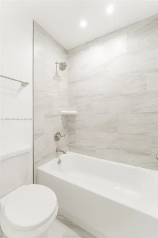 a bathroom with a toilet and a bathtub