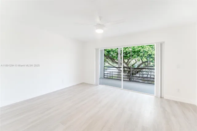 a view of a room with wooden floor and windows