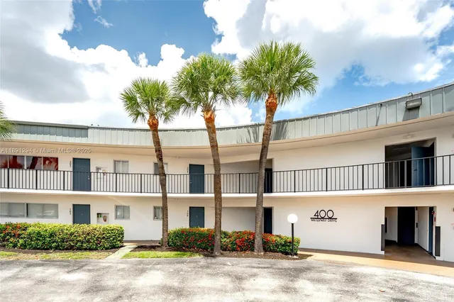 a front view of multiple houses with yard