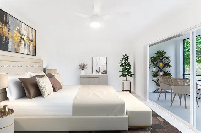 a bedroom with a large bed and paintings on the wall