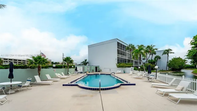 a swimming pool with outdoor seating and yard