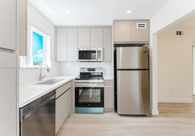 a kitchen with a refrigerator sink and stove