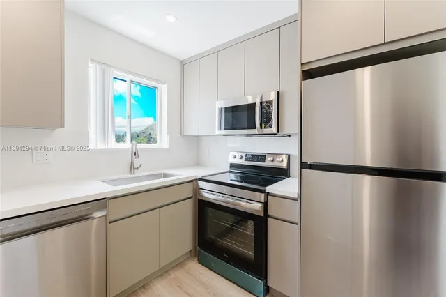 a kitchen with a refrigerator a sink and a stove