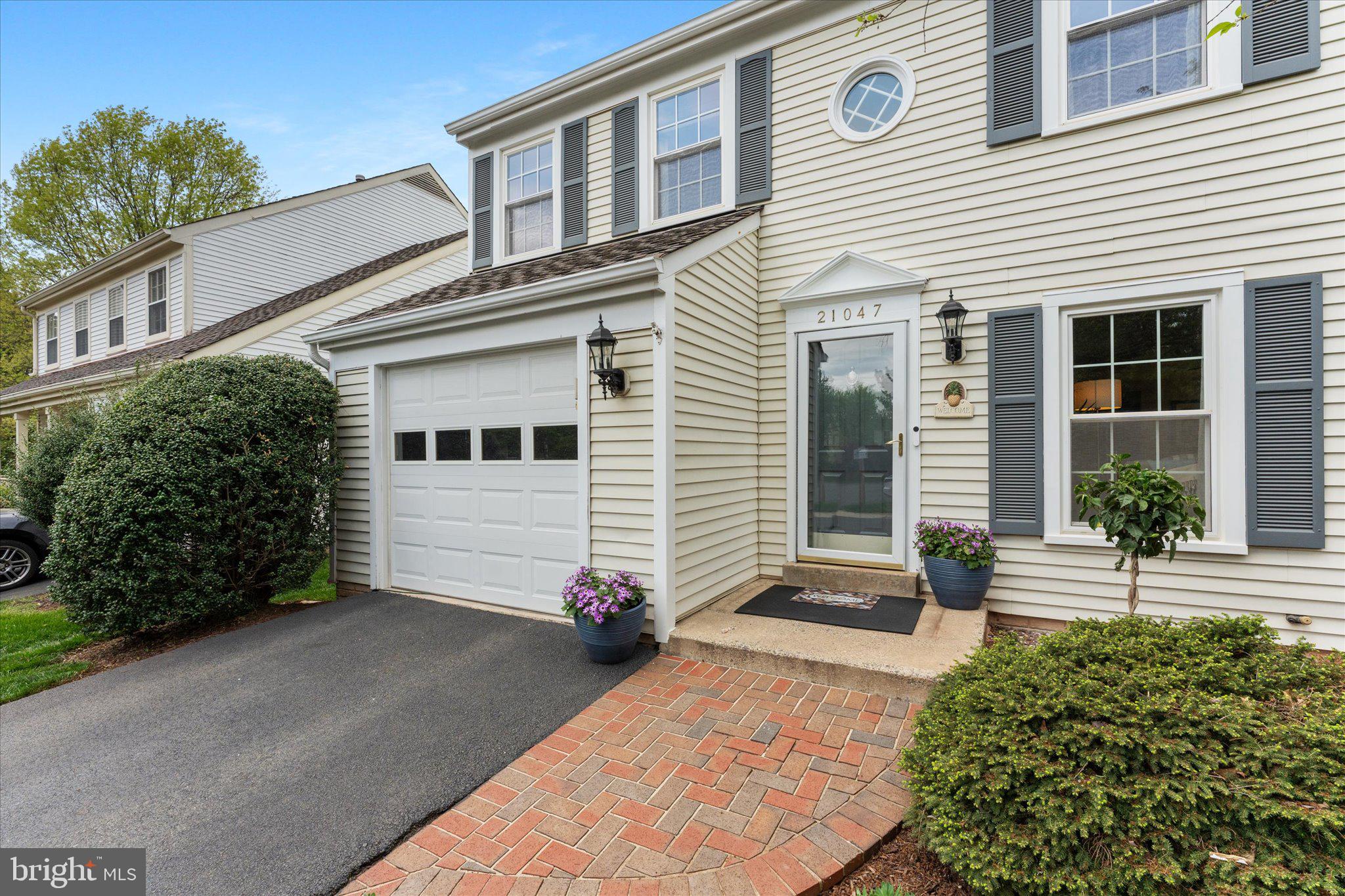 21047 Barcroft Way Sterling, VA 20164 - Photo 2 of 47 a front view of a house with a yard