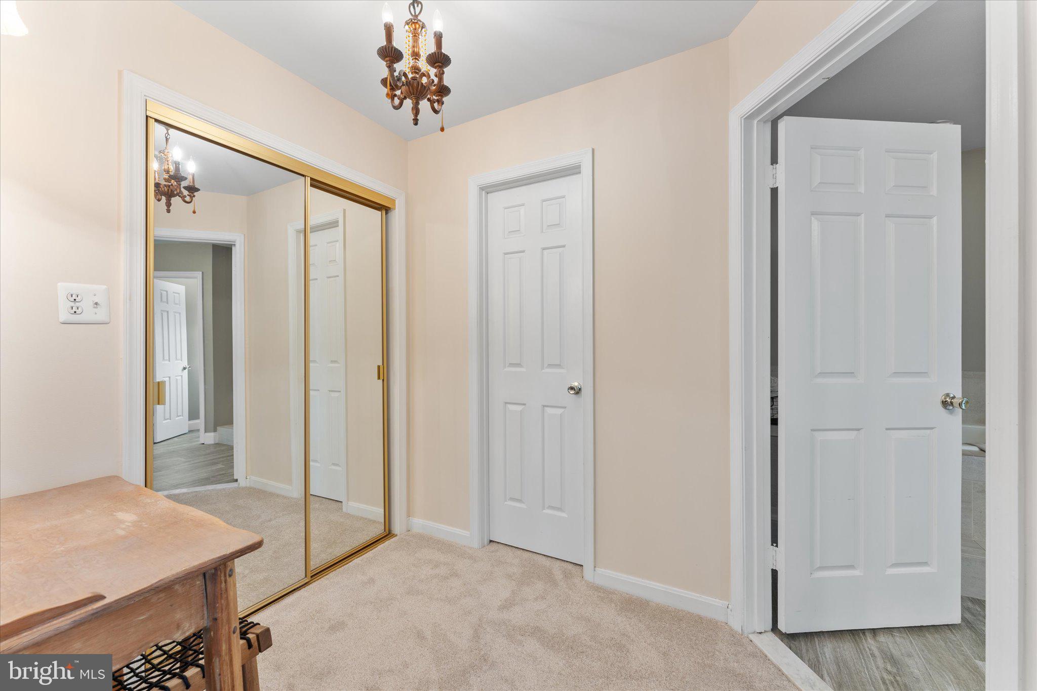 21047 Barcroft Way Sterling, VA 20164 - Photo 21 of 47 a view of a room with a chandelier closet and wooden floor
