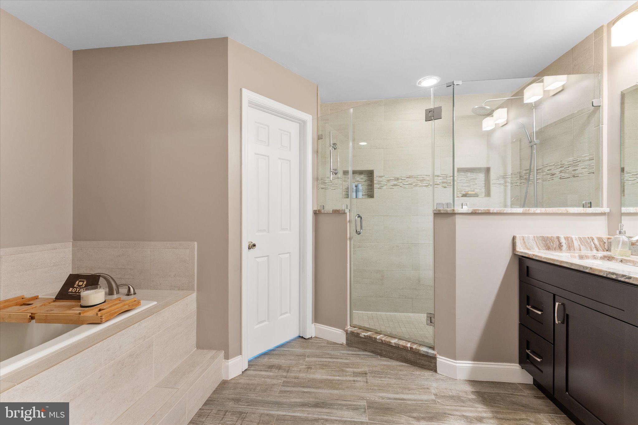 21047 Barcroft Way Sterling, VA 20164 - Photo 27 of 47 a bathroom with a tub sink and mirror