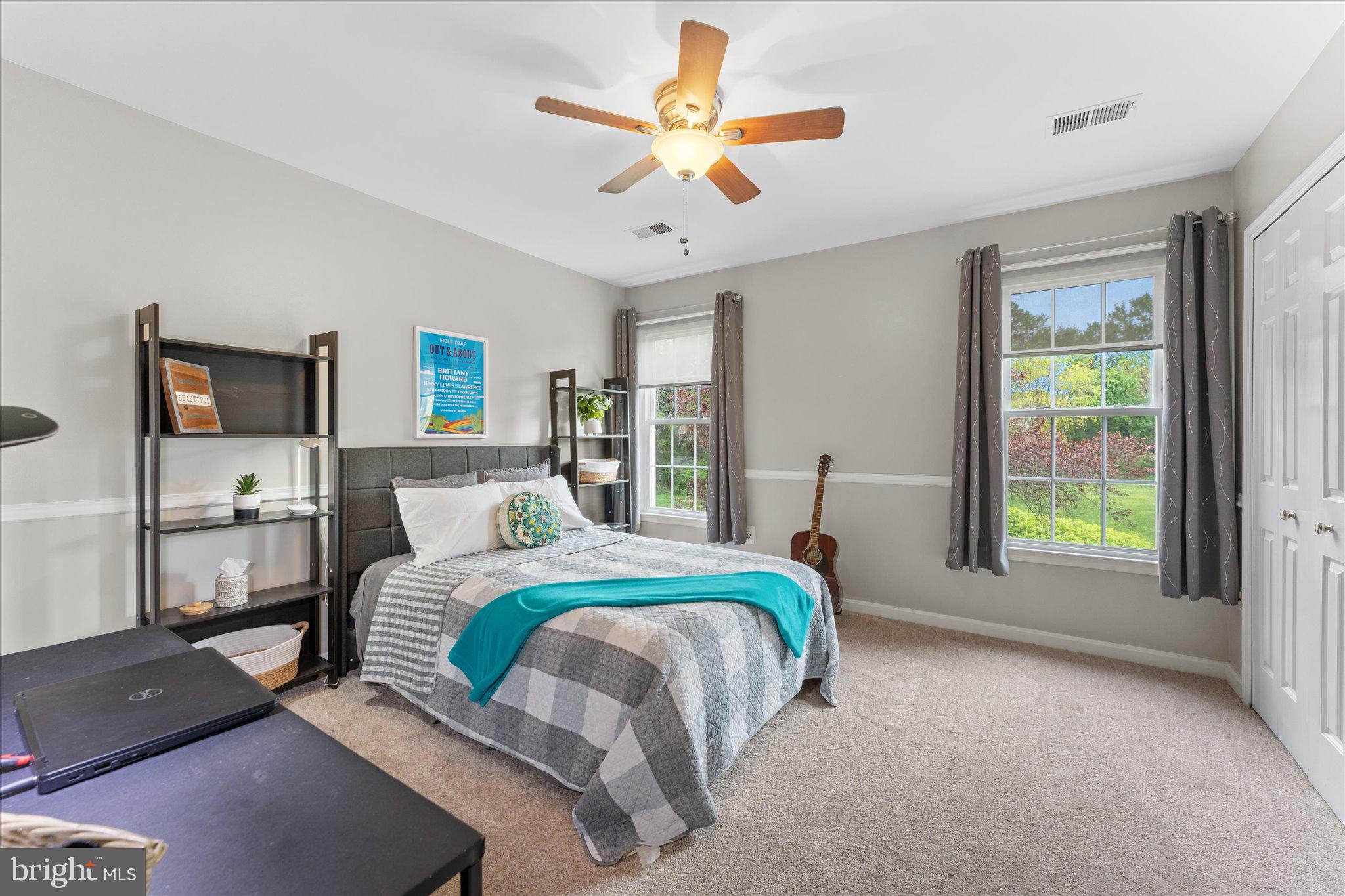 21047 Barcroft Way Sterling, VA 20164 - Photo 28 of 47 a bedroom with a bed and a chandelier