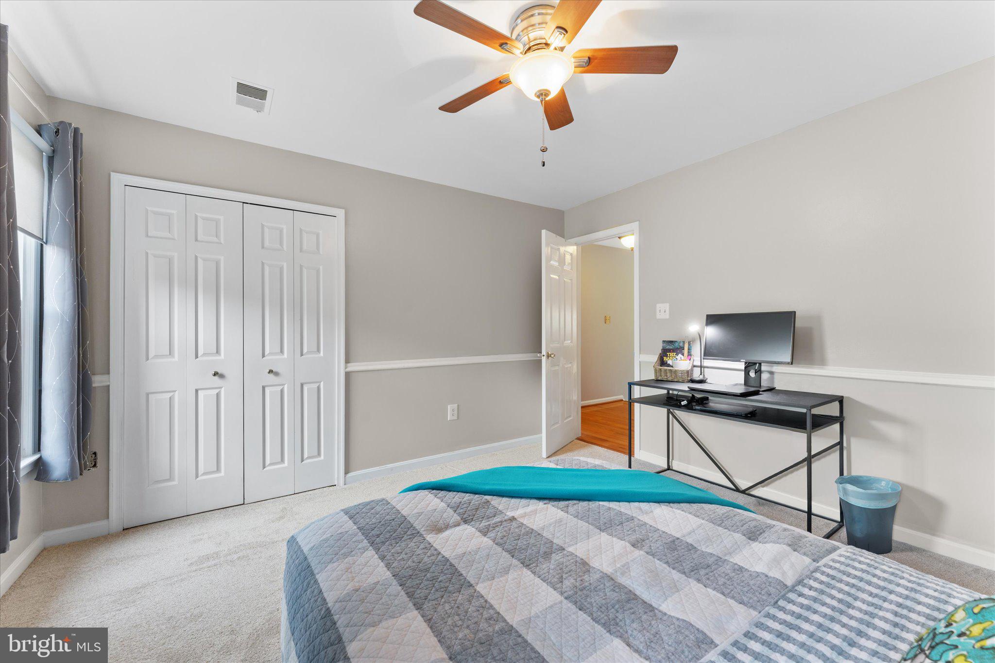 21047 Barcroft Way Sterling, VA 20164 - Photo 29 of 47 a room with a bed and a chandelier