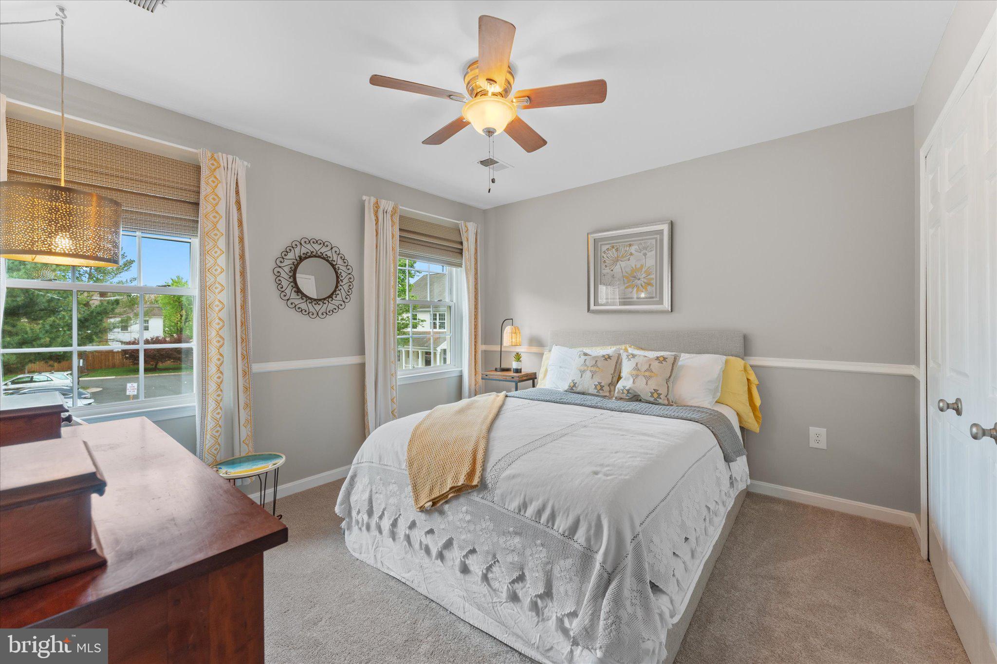 21047 Barcroft Way Sterling, VA 20164 - Photo 30 of 47 a bedroom with a bed and a chandelier