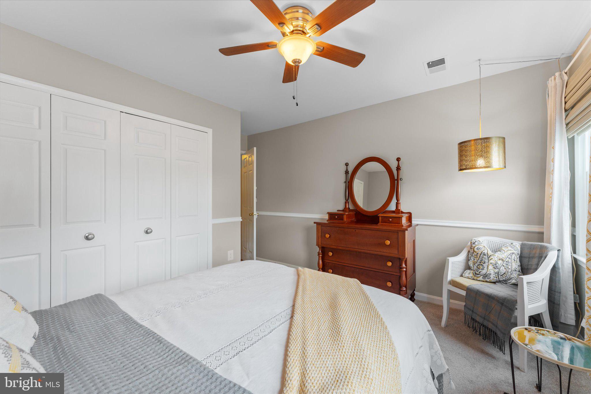21047 Barcroft Way Sterling, VA 20164 - Photo 31 of 47 a bedroom with a bed and a chandelier