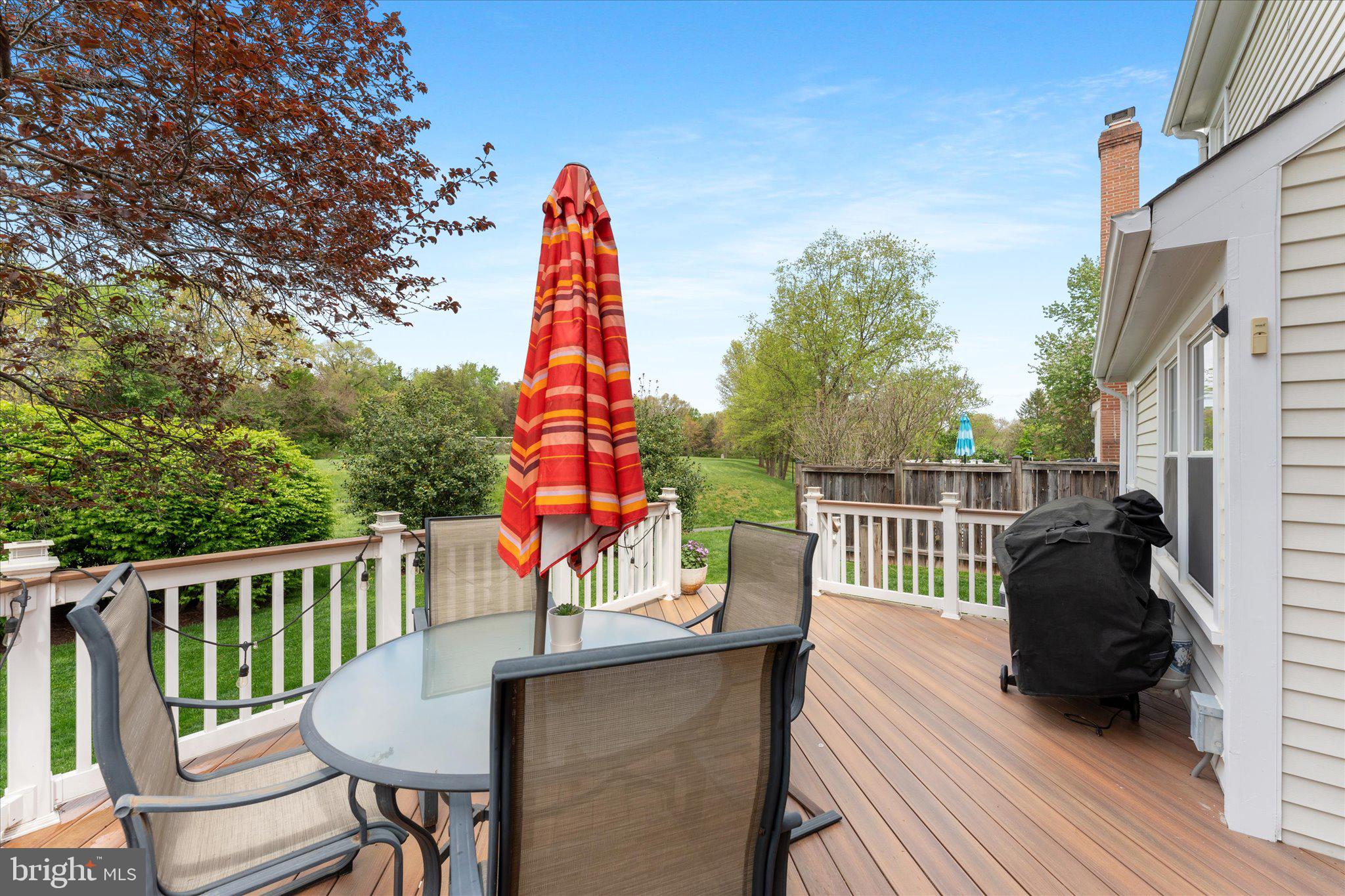 21047 Barcroft Way Sterling, VA 20164 - Photo 38 of 47 a view of a deck with a table and chairs a barbeque with wooden floor and fence