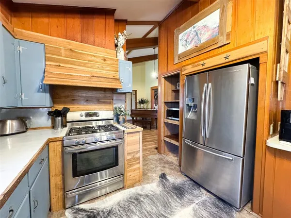 a view of a kitchen with appliances and cabinets