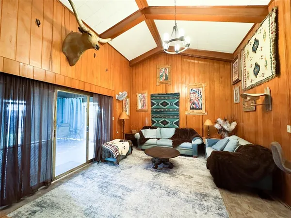 a view of a livingroom with furniture and a window