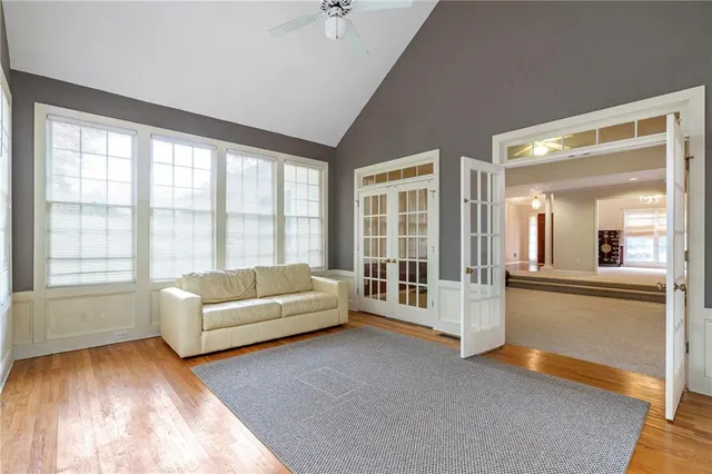 a living room with furniture and large windows