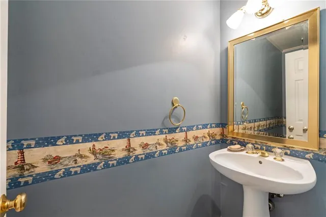 a bedroom with a balcony a bed and a chandelier