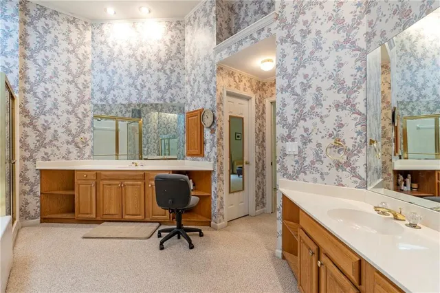 an empty room with windows and chandelier fan