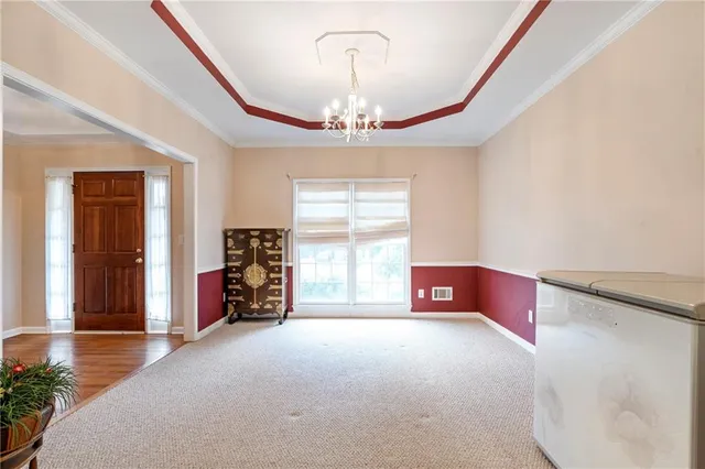 a view of a livingroom with furniture and a chandelier