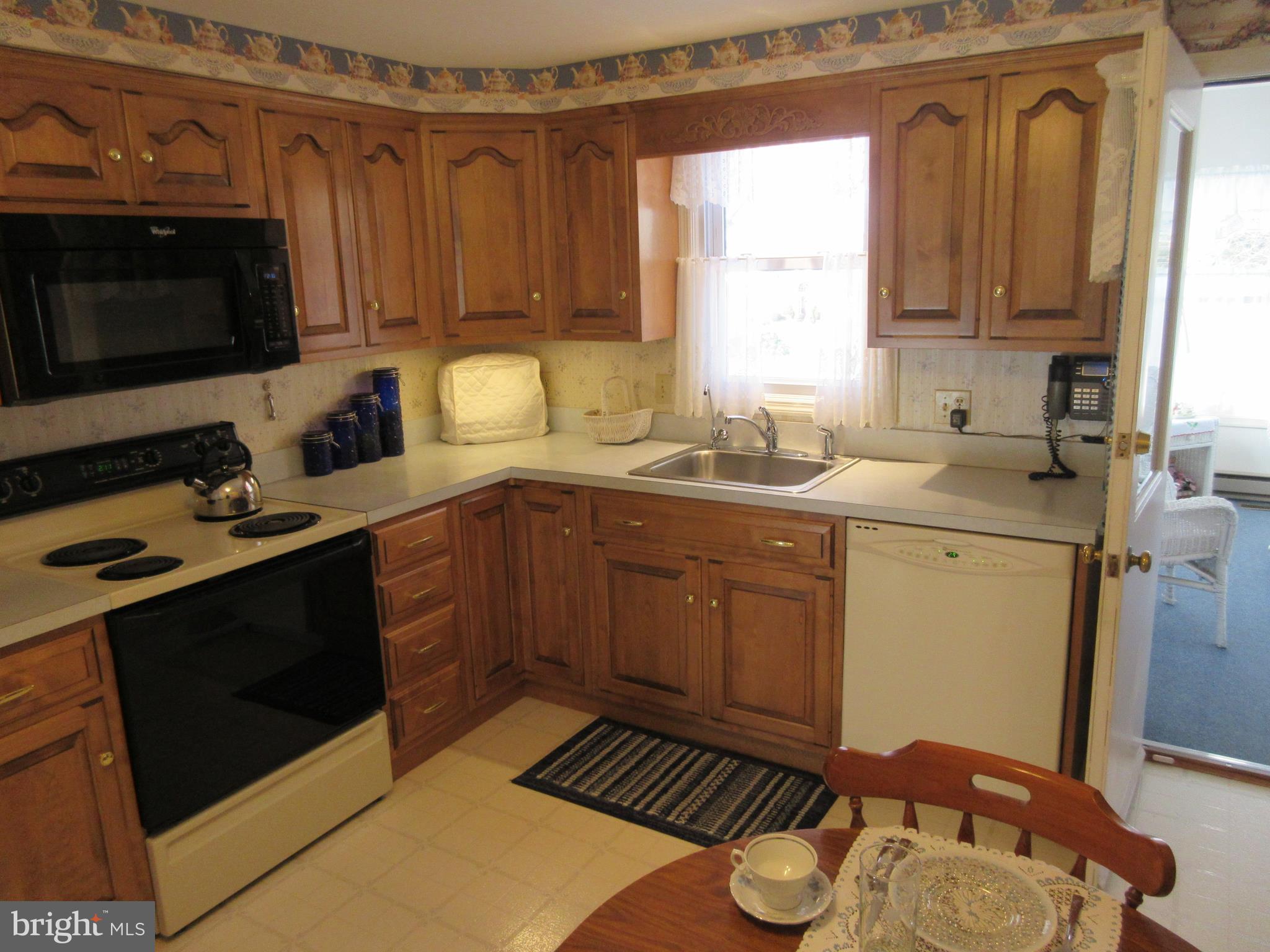 160 April Lane Lititz, PA 17543 - Photo 5 of 27 a kitchen with stainless steel appliances a sink a stove a microwave cabinets and a counter top space