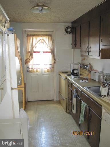 3908 Misty View Road Middle River, MD 21220 - Photo 6 of 20 a kitchen with stainless steel appliances a stove a sink and a refrigerator