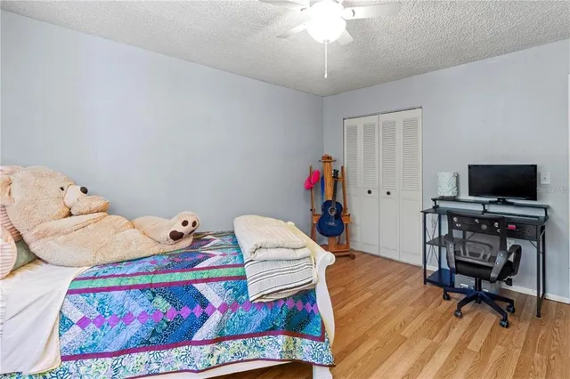a bedroom with furniture and a flat screen tv