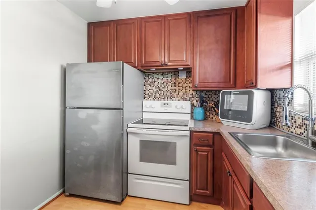 a kitchen with a sink stove and refrigerator