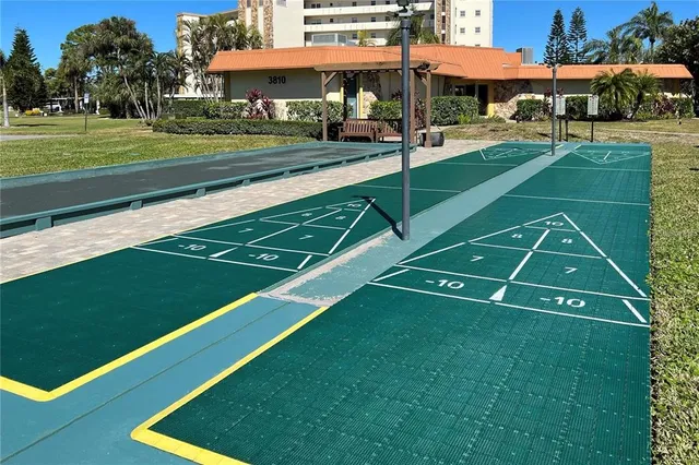 a view of a patio with a table and chairs under an umbrella