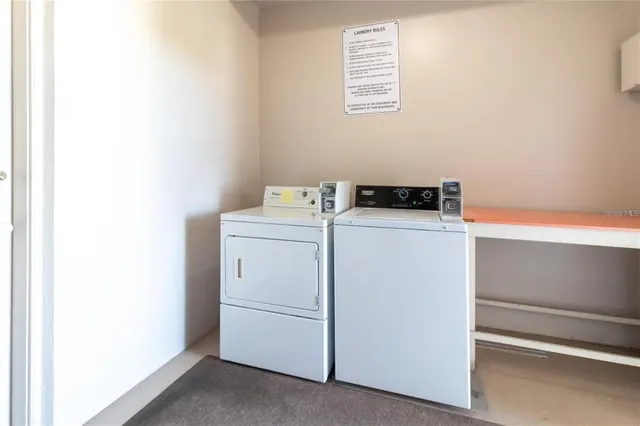 a street sign on a wall next to a road