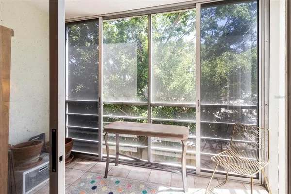 a room with a floor to ceiling window and wooden floor
