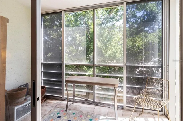 a room with a floor to ceiling window and wooden floor